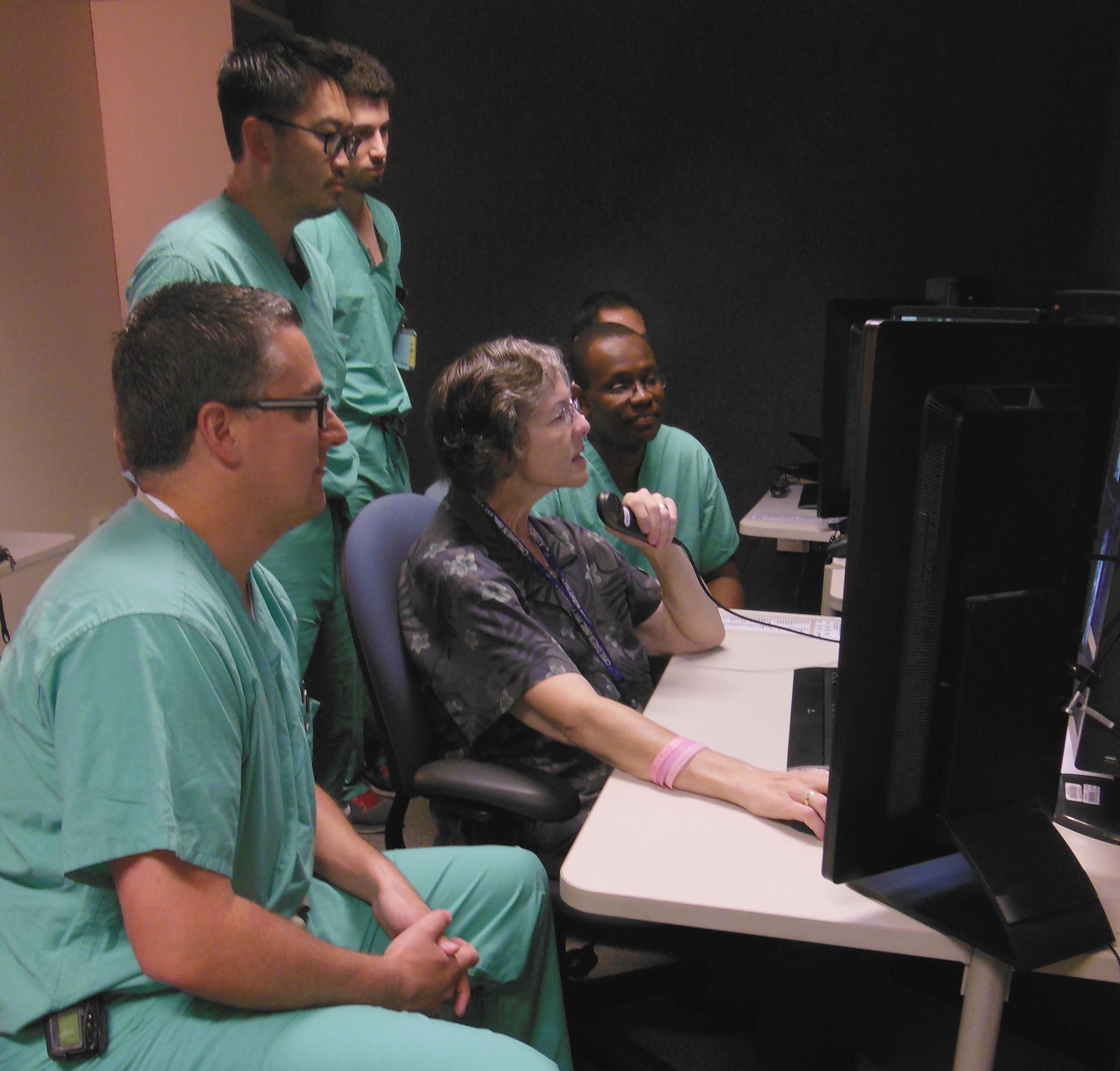 Dr Mike Saint-Louis (to left of instructor) studies pediatric imaging for one month elective at UC Davis.